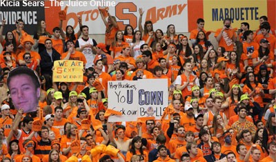 Syracuse's crowd at the Carrier Dome holds up signs during a timeout