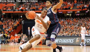 Syracuse forward Kris Joseph drives against UConn